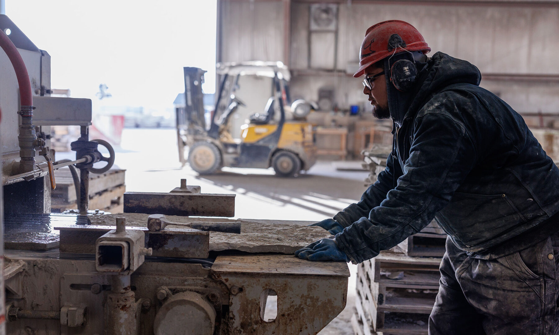 A Rademann stone cutting employee operating equipment